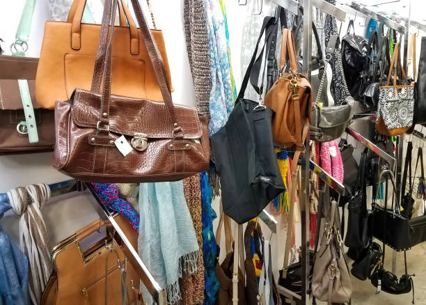 Thrift store racks of purses on display.