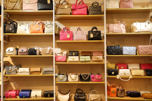Close up female hand bags in retail store