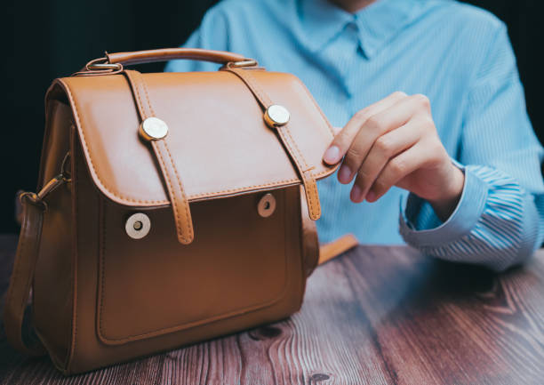 A charming leather handbag showcasing its elegant design on a wooden table