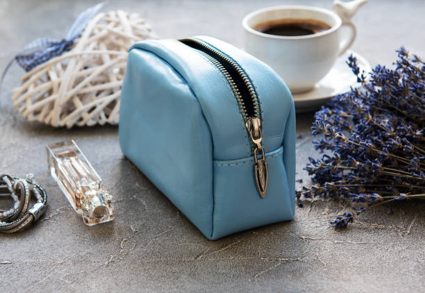 Leather cosmetic bag with accessories on a stone background