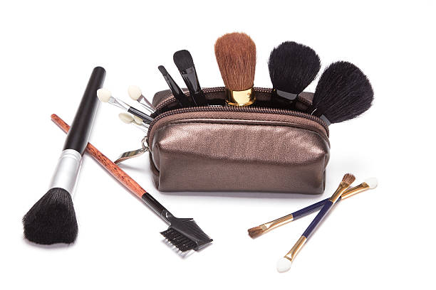 Makeup case with brushes for eyebrows, eyeshadow, temel, powder, lipstick and applicators on white background